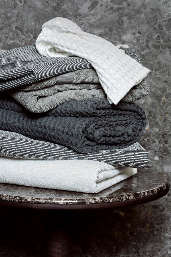 Stack of towels in different shades of grey