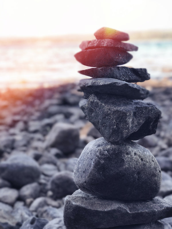 Rocks balancing on top of each other on a stone beach